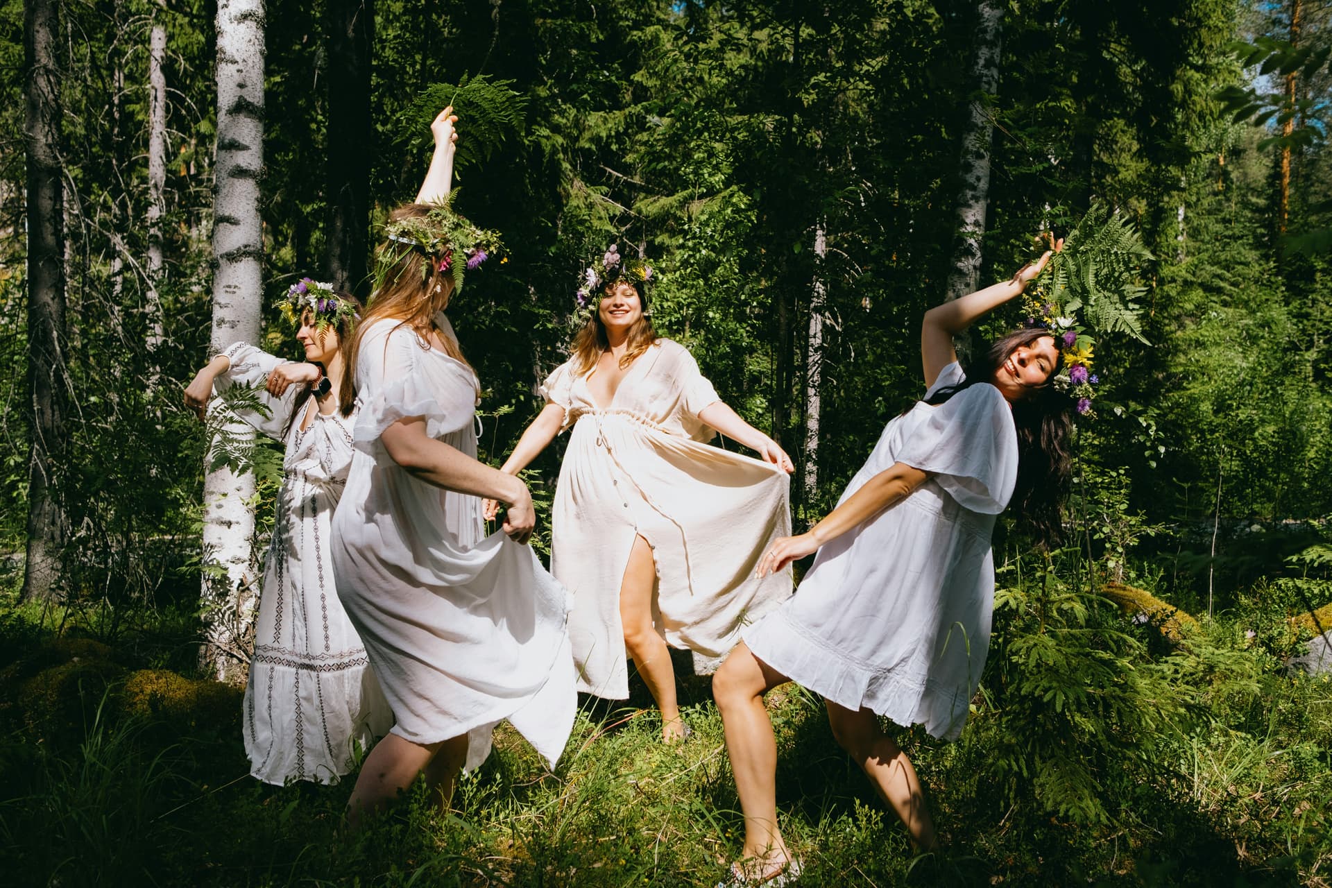 A Swedish Midsummer gathering outdoors with long tables and summer light